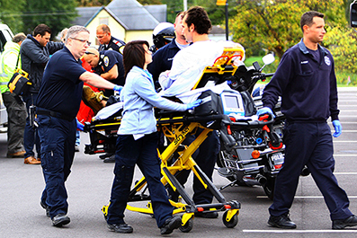 Paramedics move a patient on a stretcher